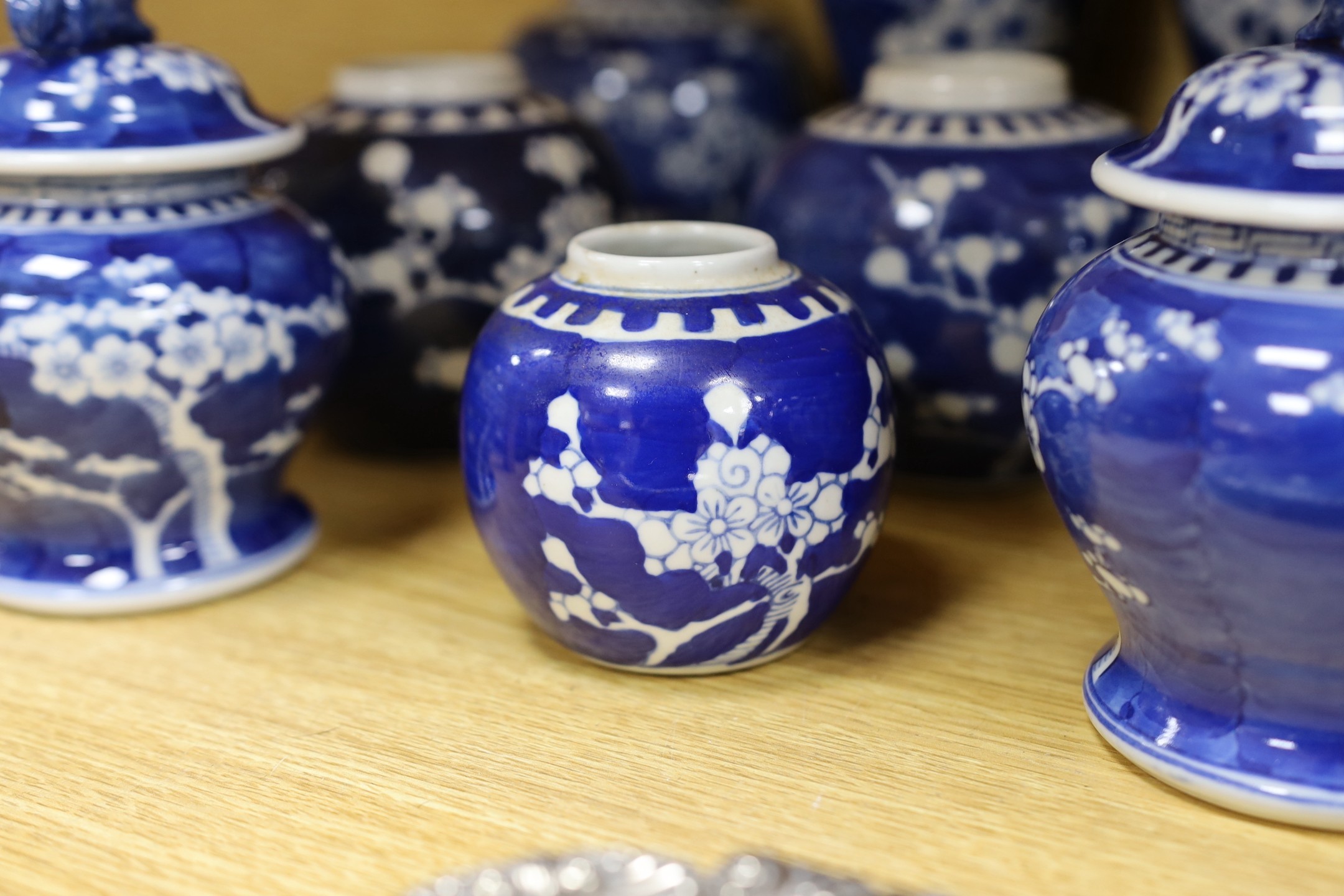 A group of Chinese blue and white prunus vases and jars and covers and jars, pair of vases 23 cms high